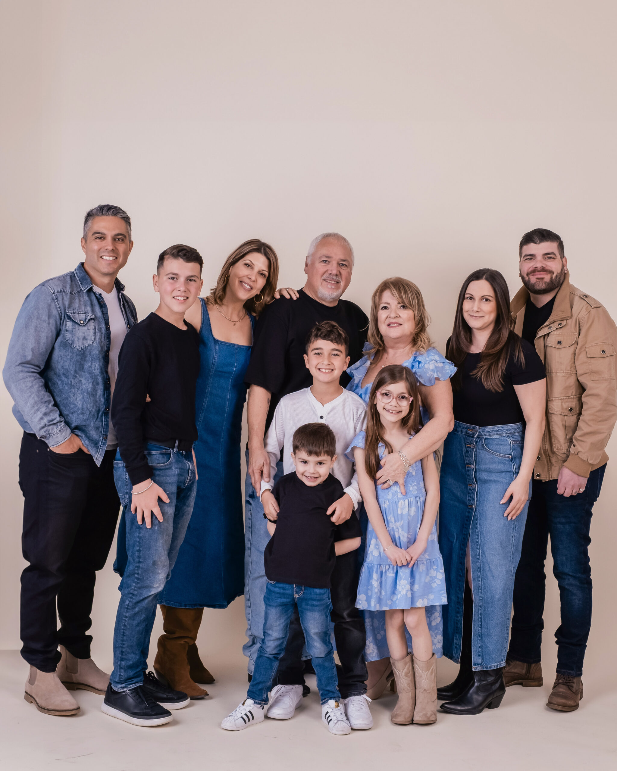 Extended family gathered together smiling during an outdoor family photography session in Milton, Ontario